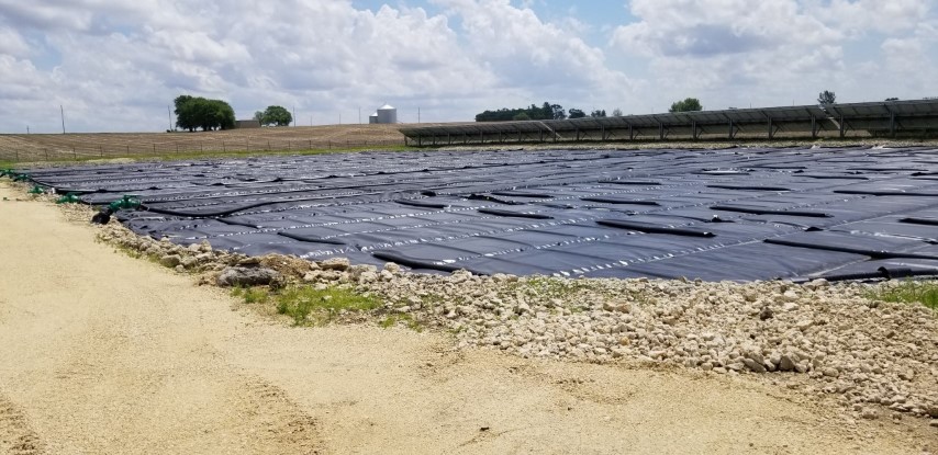 Solar panels with a wastewater treatment plant, showing one way to reduce treatment plant energy consumption